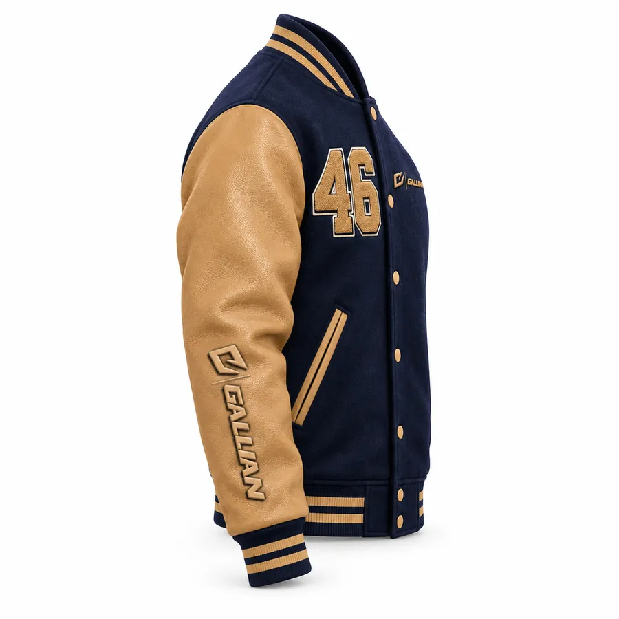 Side angle of navy varsity jacket showing tan sleeve, raised sleeve logo and striped rib cuff